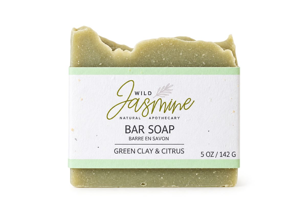 A bar of Wild Jasmine green clay and citrus soap with a white and mint label, on a clean white background.